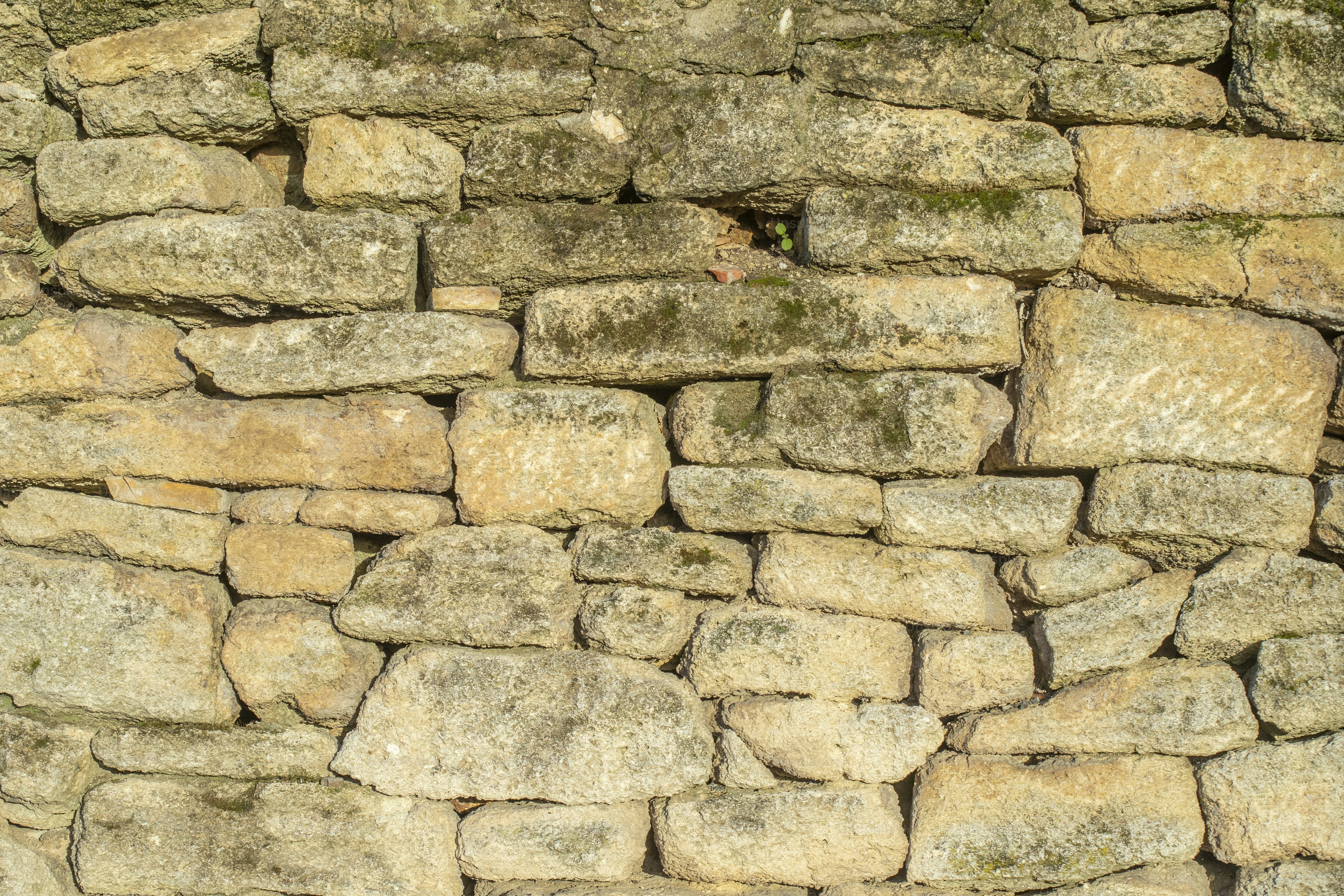 a stone wall with a clock on it