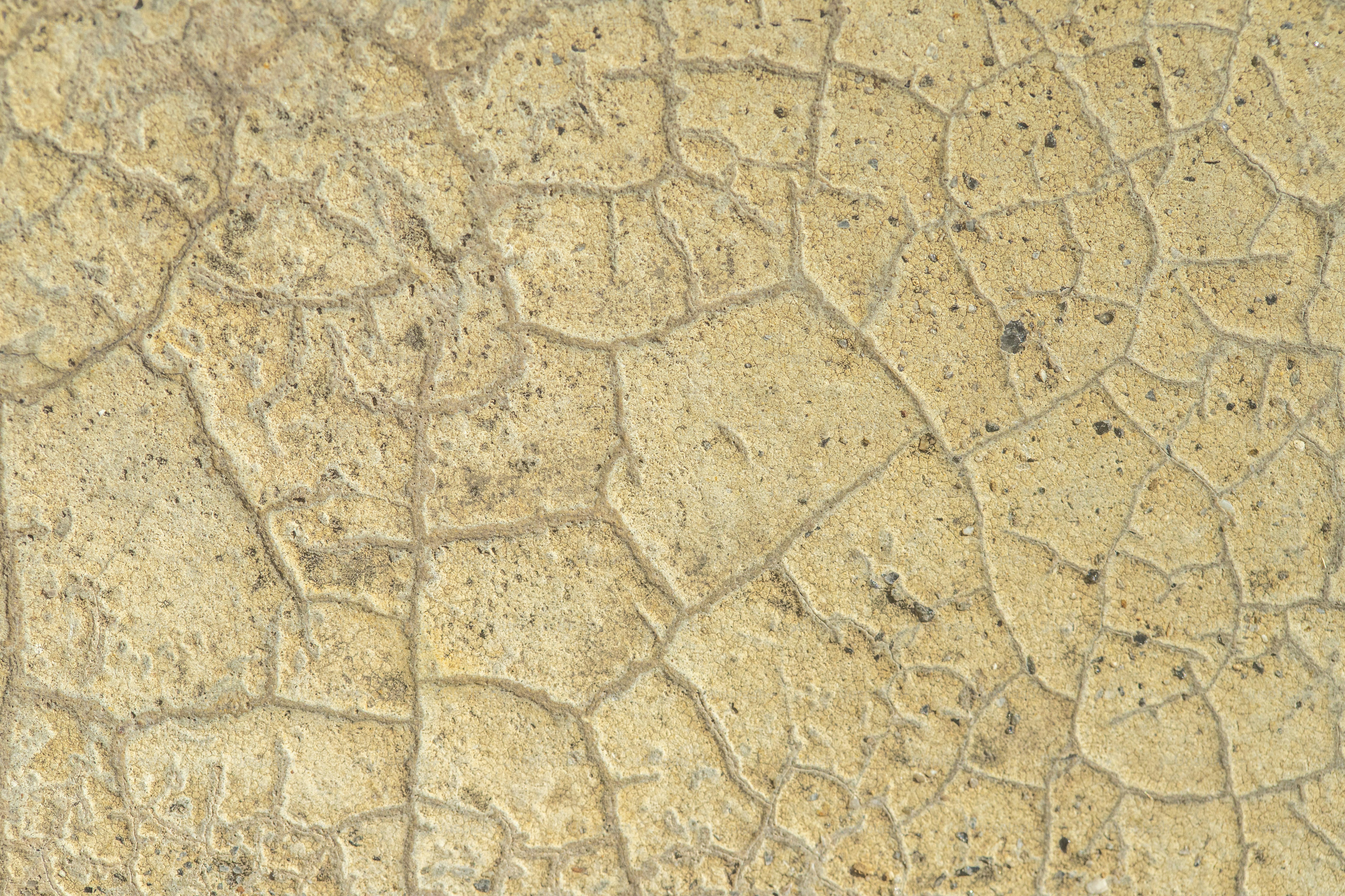 a close up of a stone surface with cracks