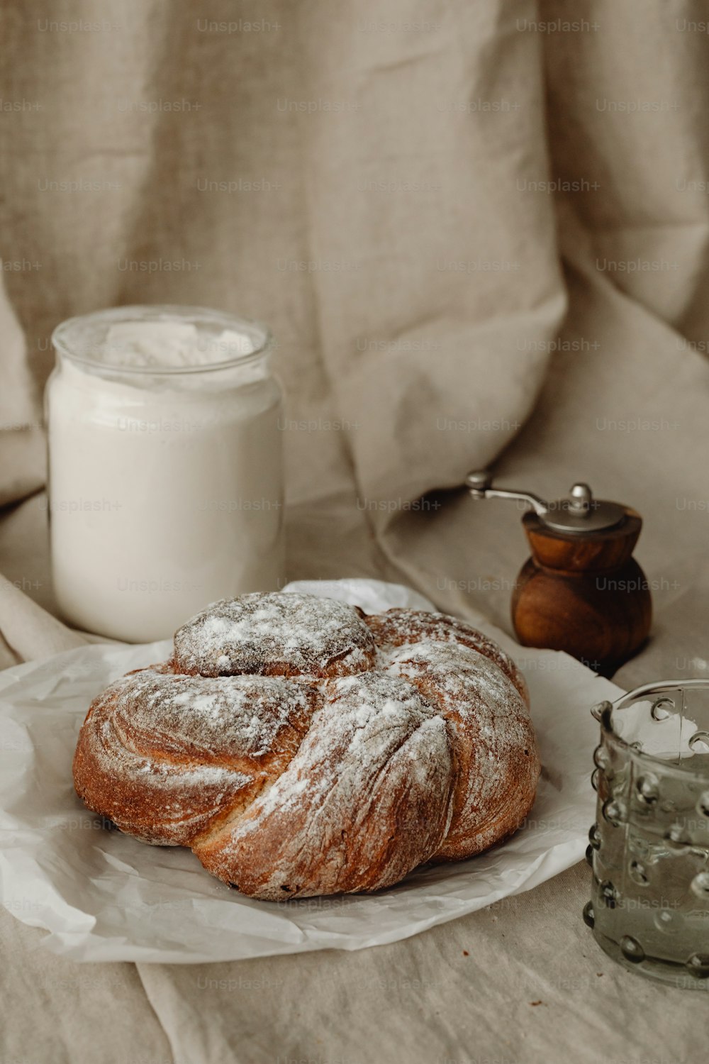 a table topped with a pastry covered in powdered sugar