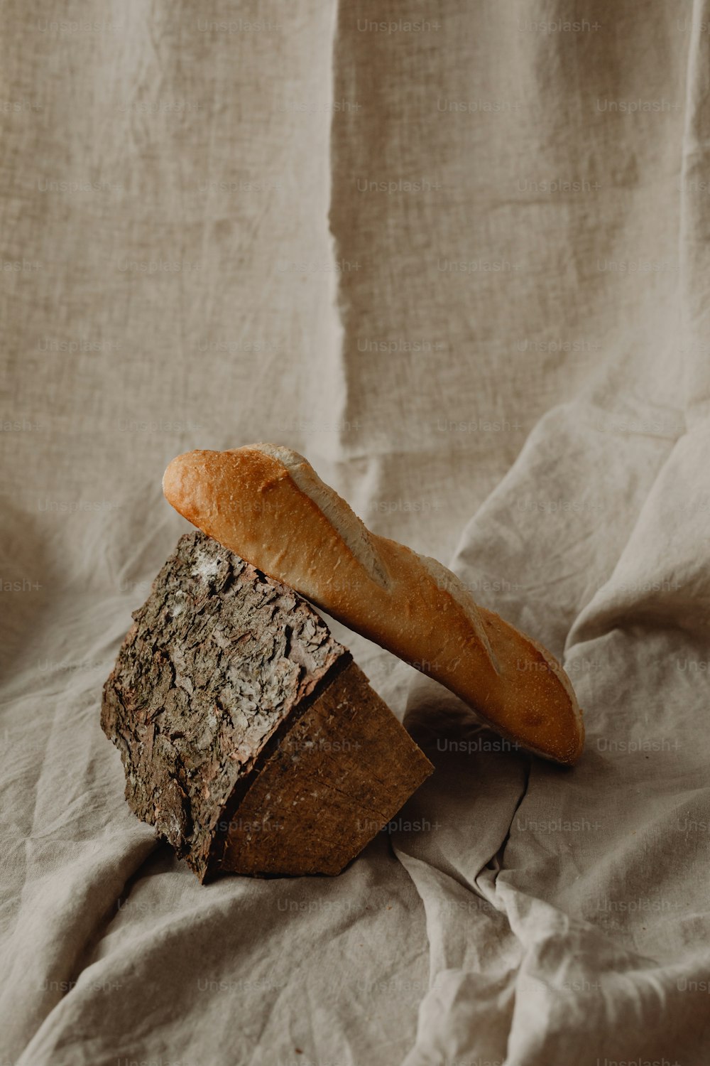 a loaf of bread sitting on top of a piece of bread