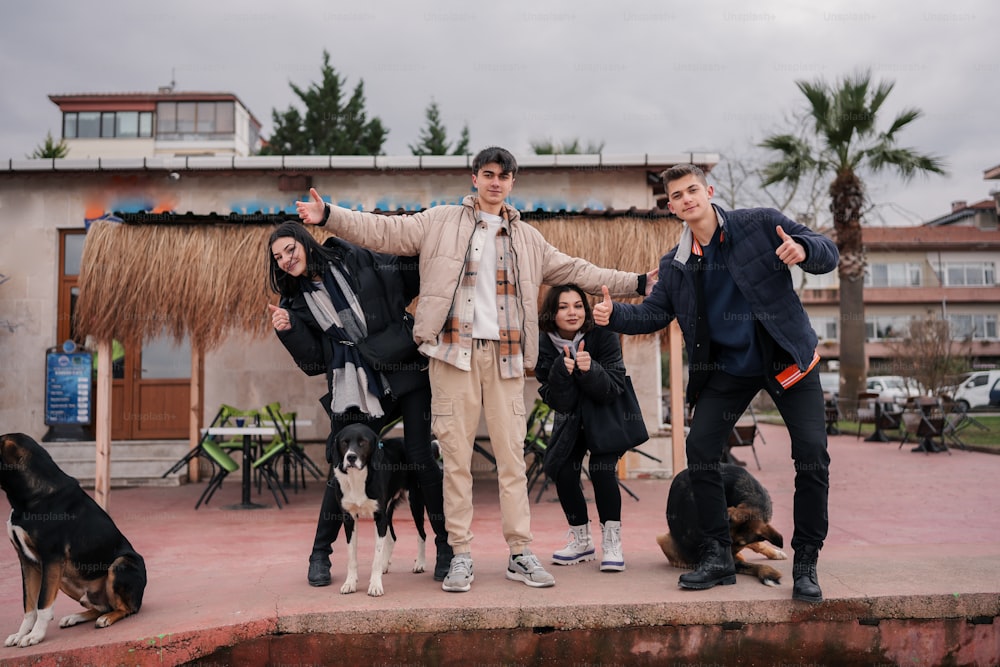 a group of people posing for a picture with their dogs