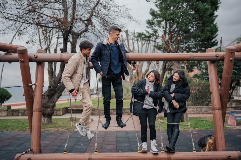 a group of people standing on top of a wooden structure
