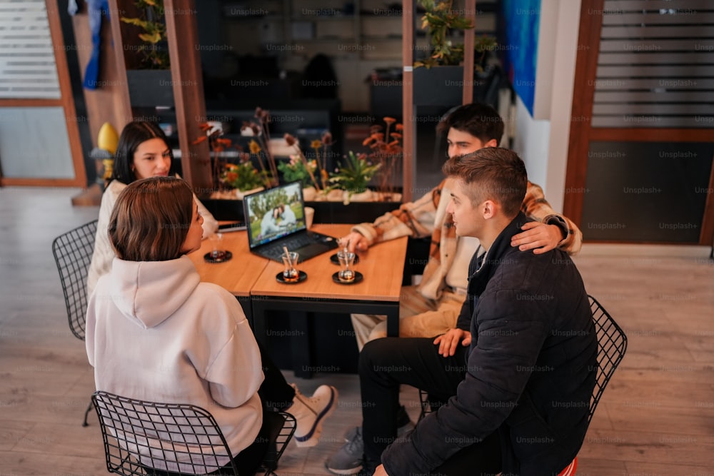a group of people sitting around a wooden table