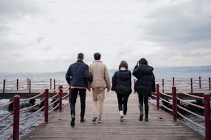 a group of people walking on a pier