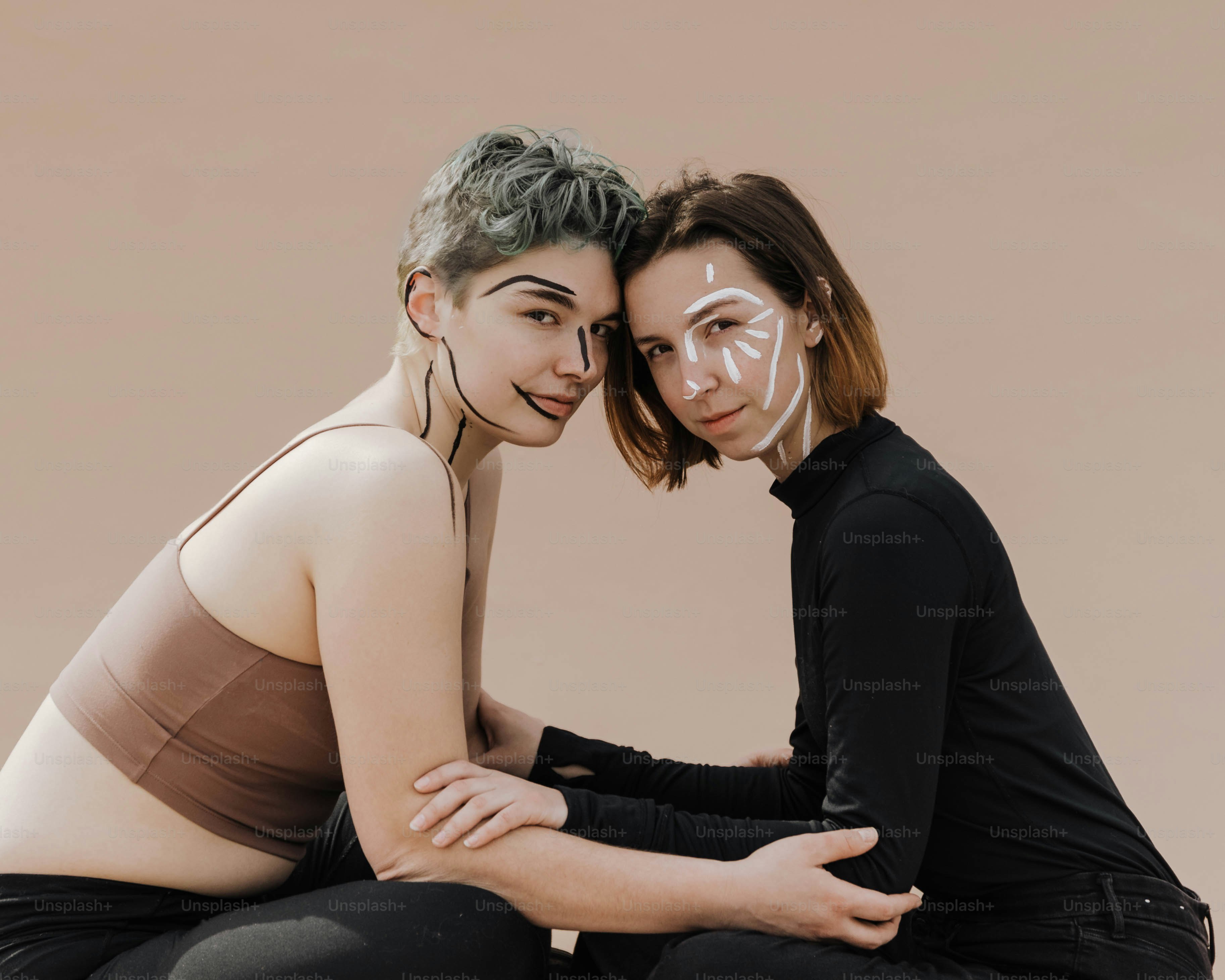 two women sitting next to each other posing for a picture