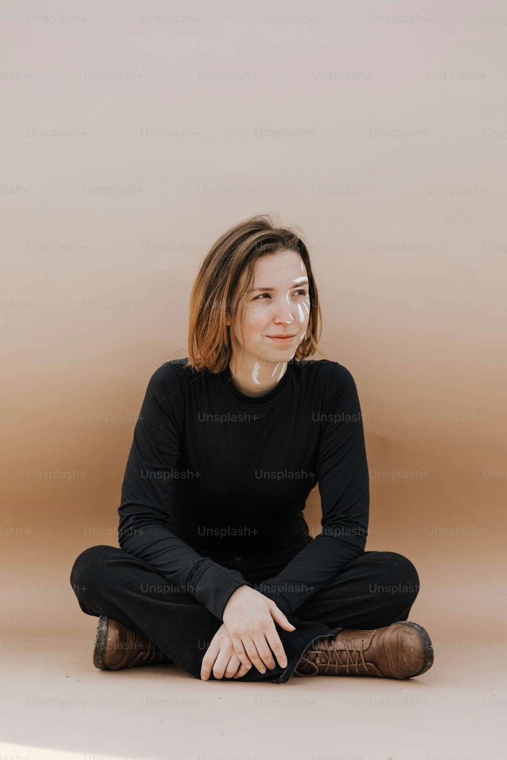 a woman sitting on the floor with her legs crossed