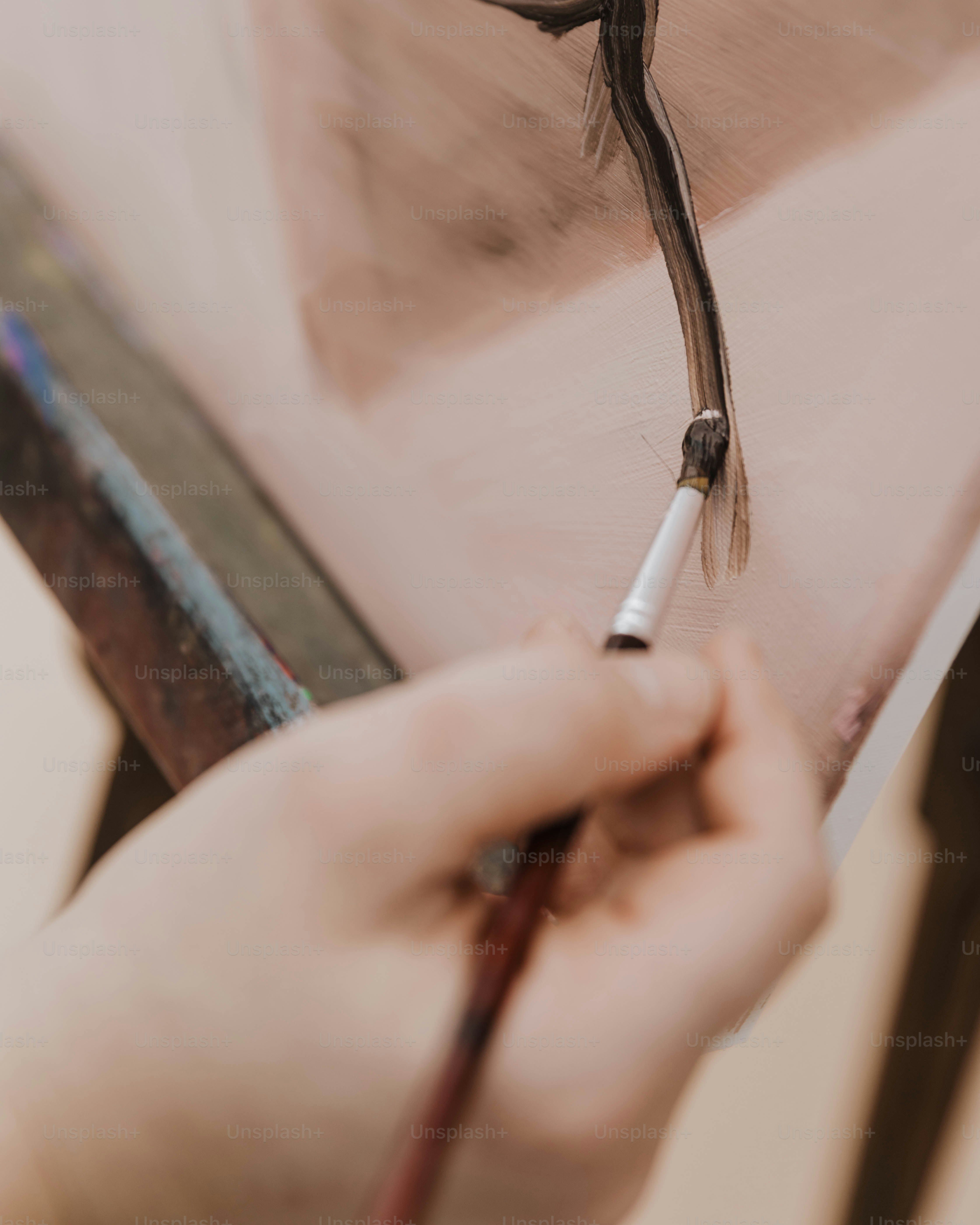 a person is painting a picture with a brush