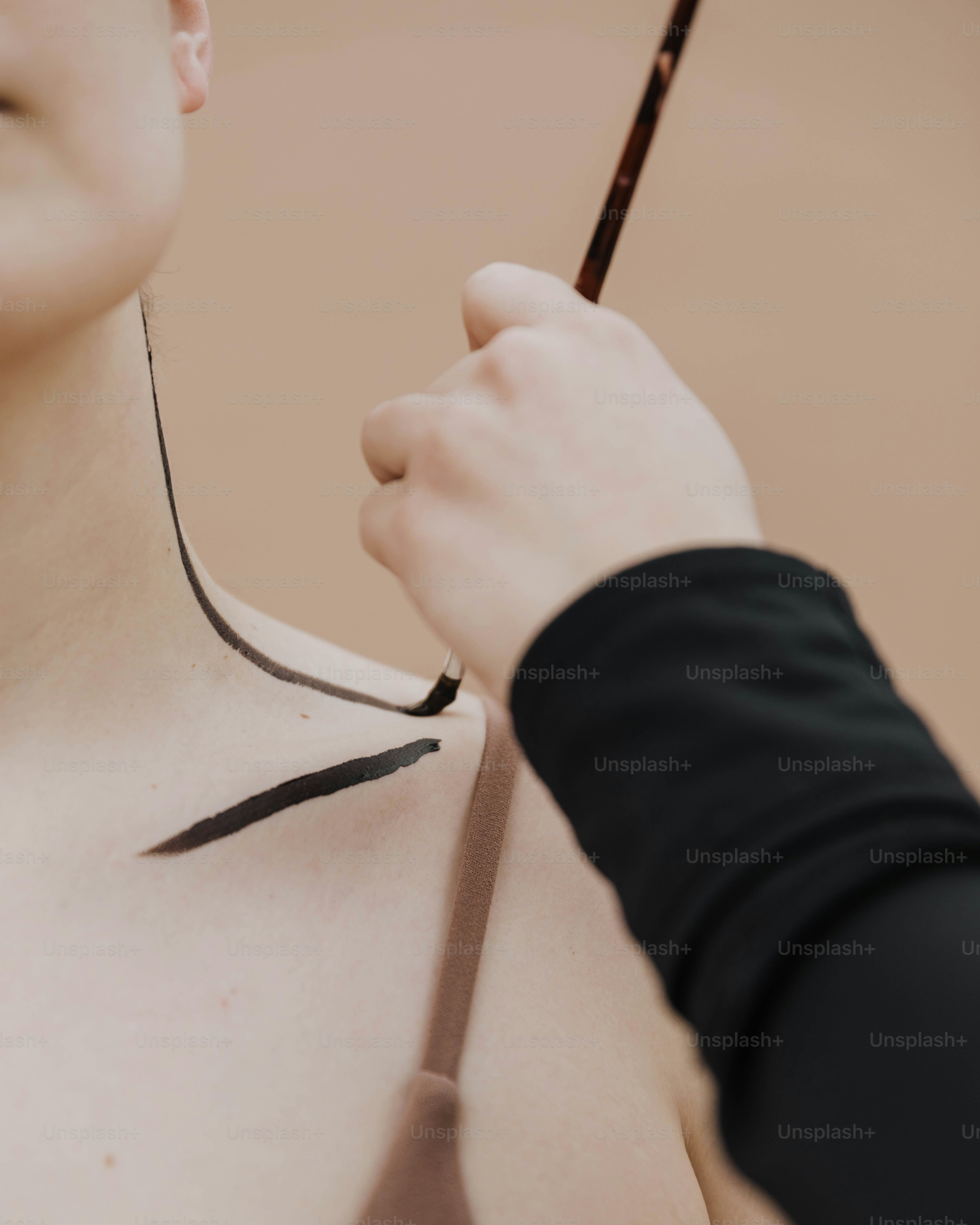 a woman getting her tattoo done by a man