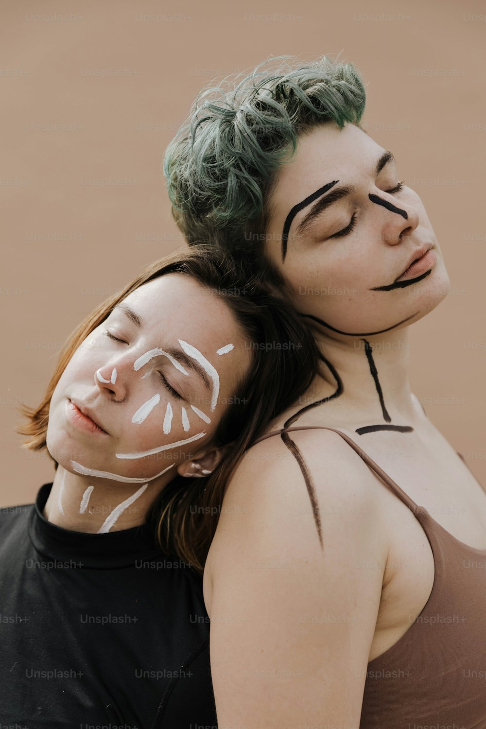a couple of women with face paint on their faces