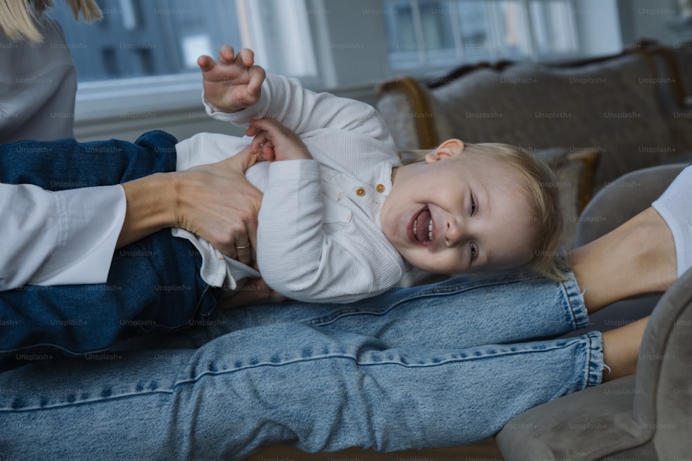 a woman holding a baby in her lap