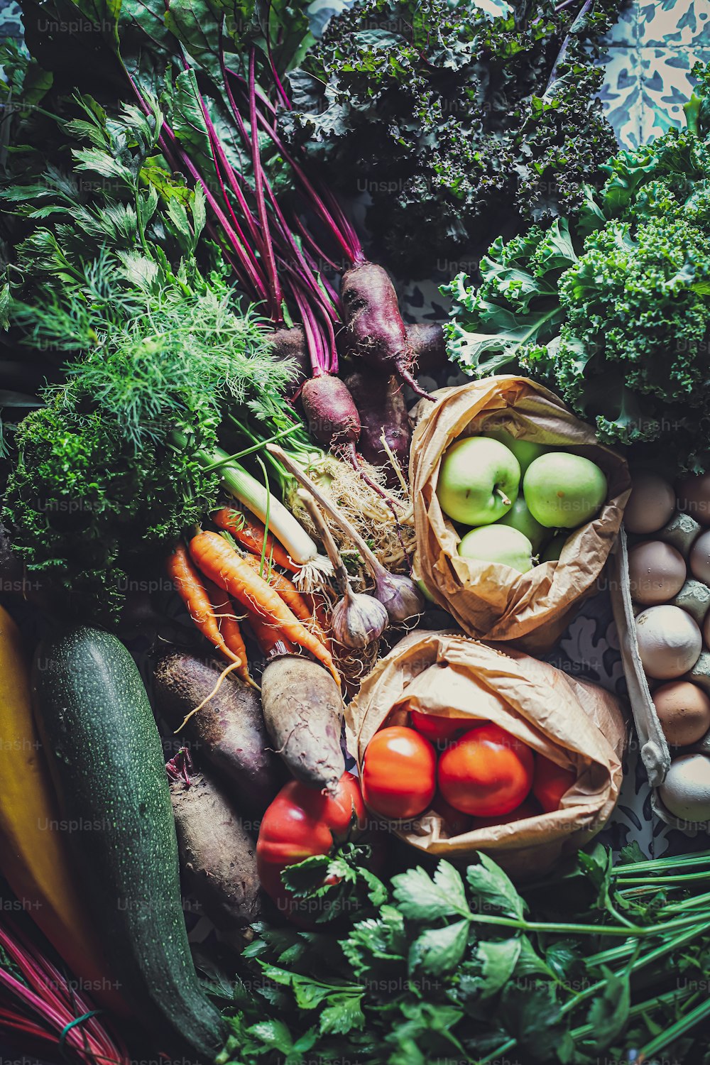 a pile of vegetables and eggs on a table