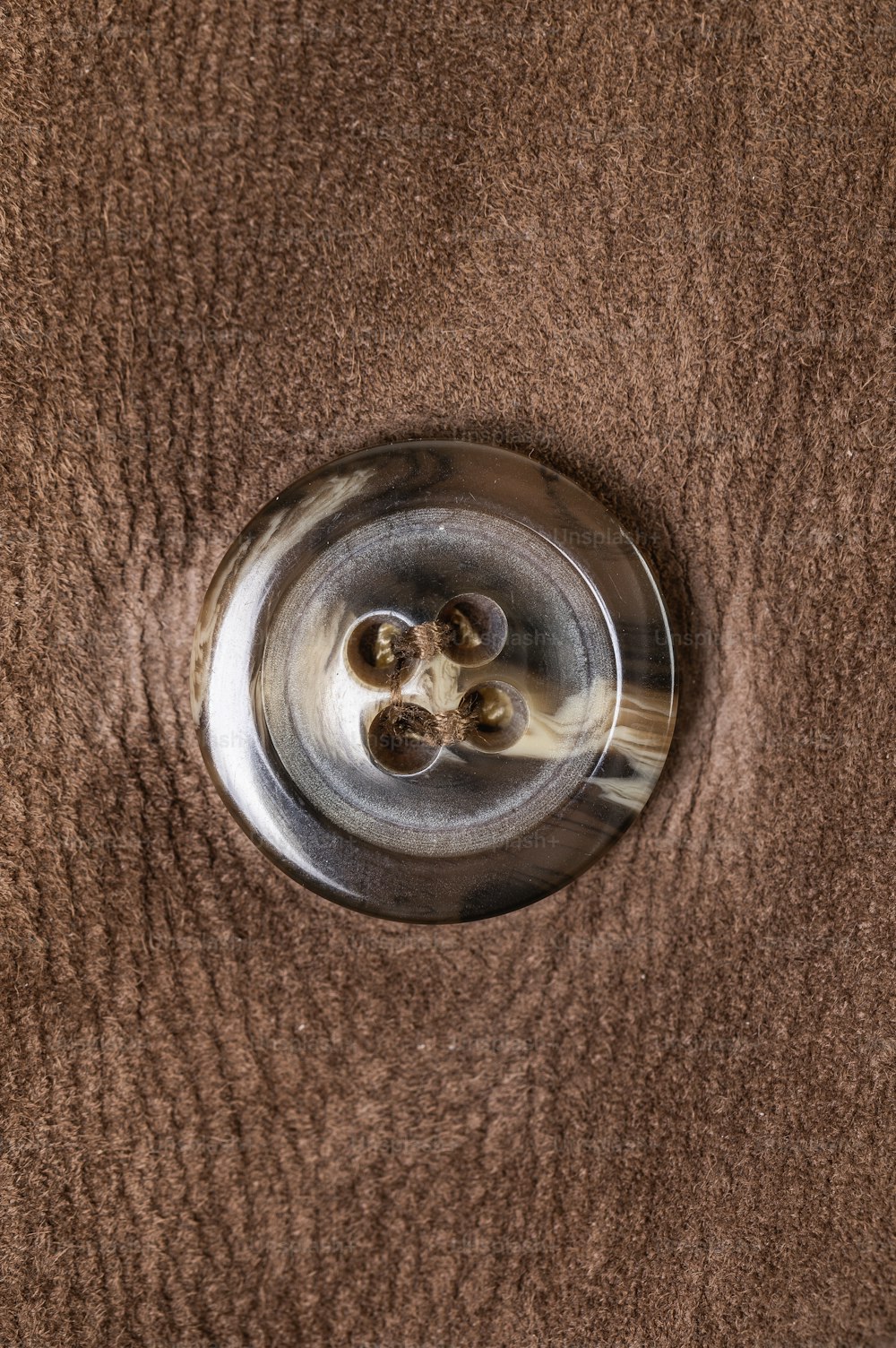 a close up of a metal object on a brown surface