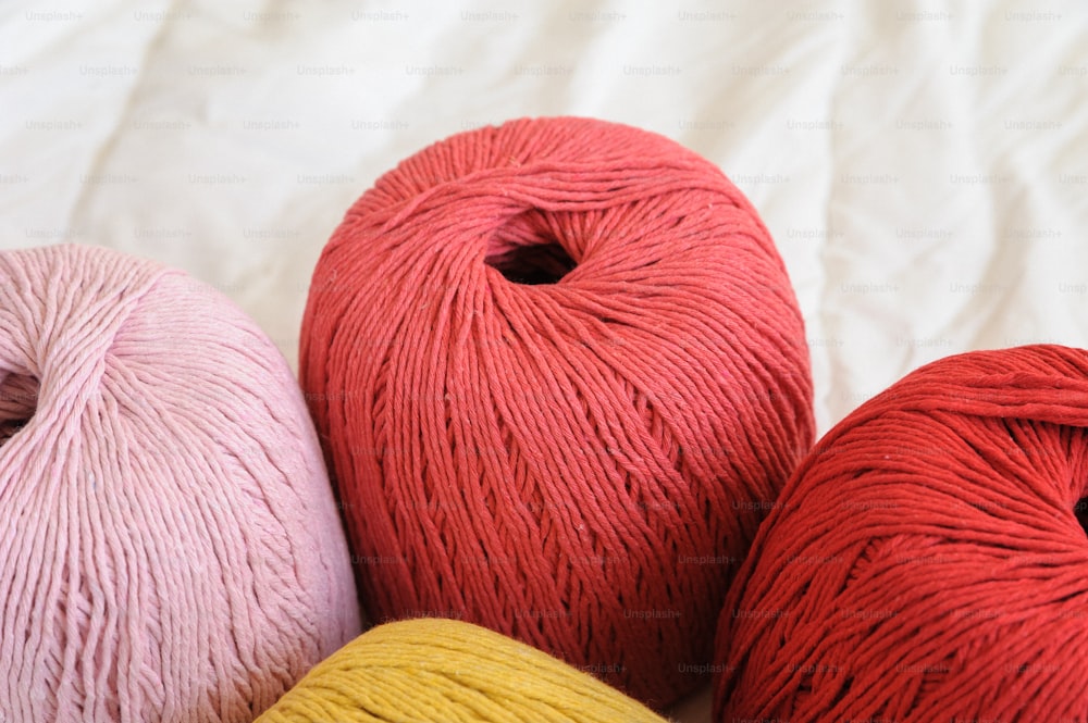 three skeins of yarn sitting next to each other