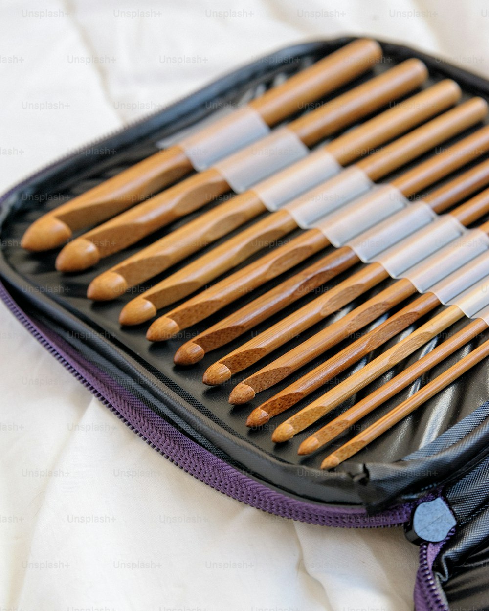 a case filled with lots of wooden spoons