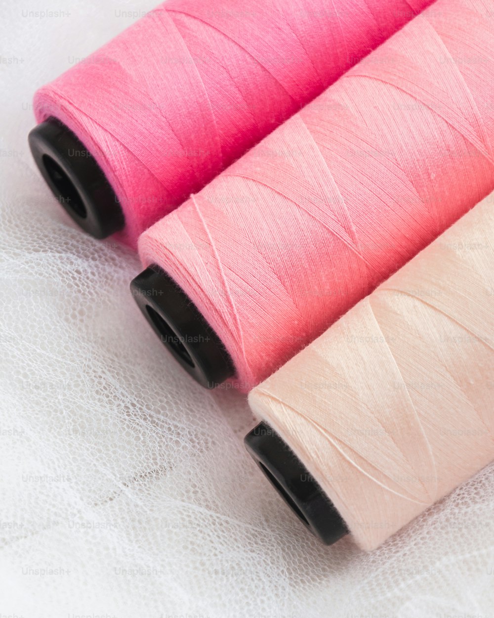 three spools of thread sitting next to each other