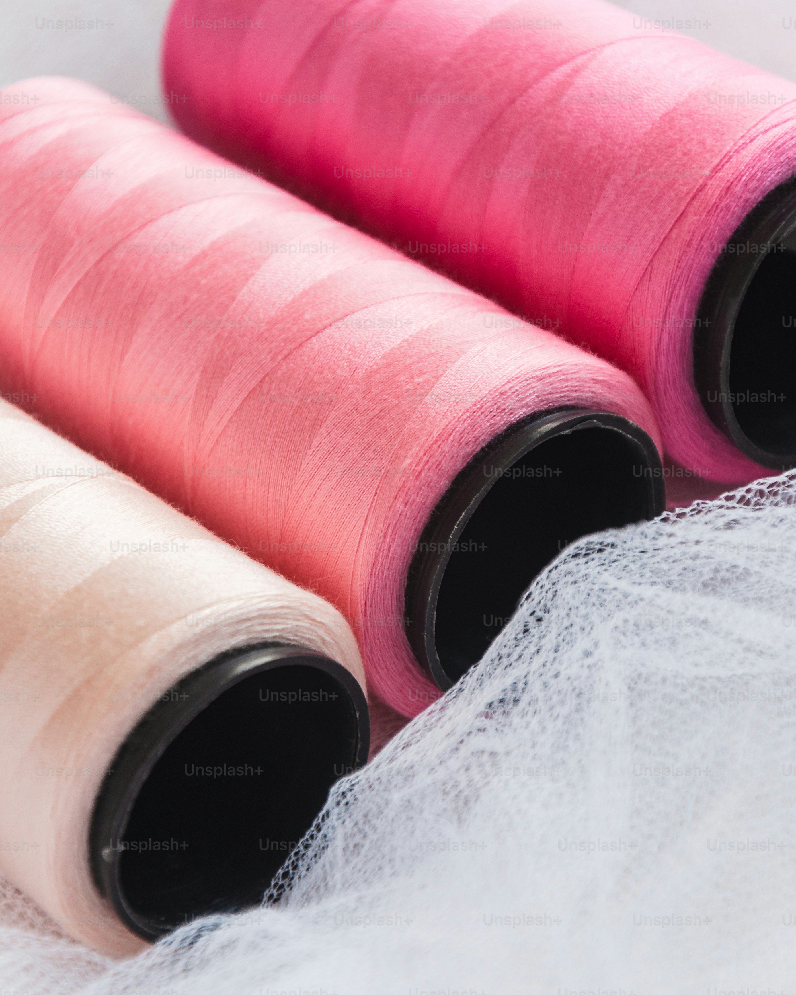three spools of thread sitting next to each other