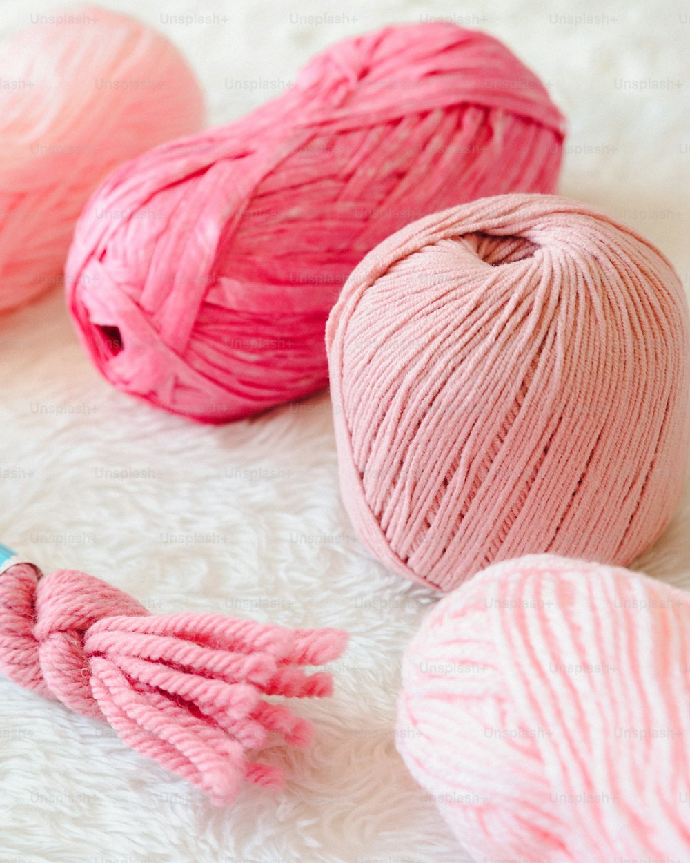three balls of yarn and a crochet hook