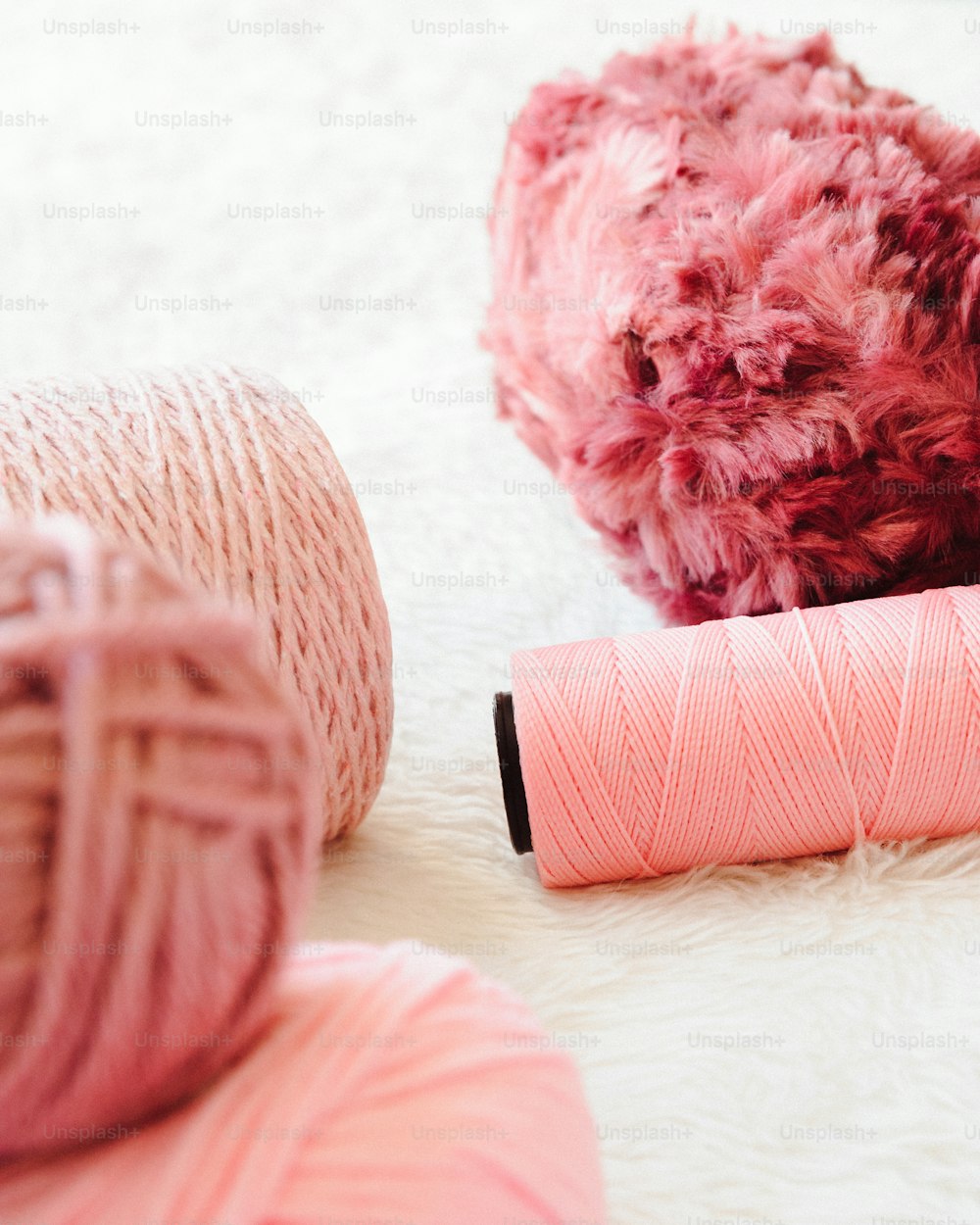 a pink ball of yarn next to a pink ball of yarn