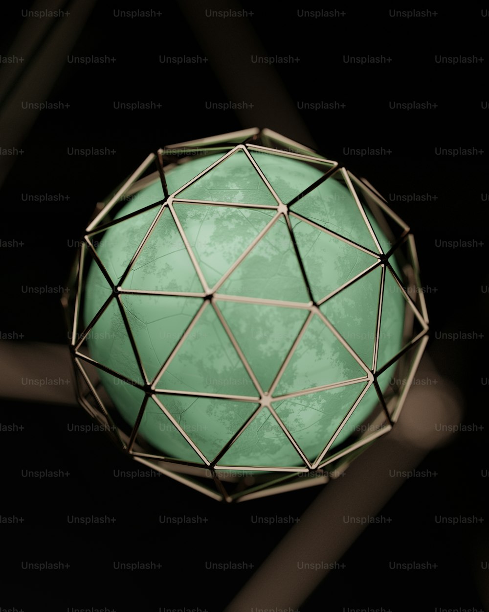 a green lamp hanging from a ceiling in a dark room