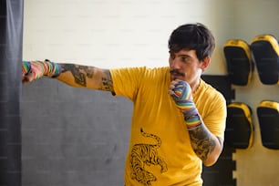 a man in a yellow shirt is holding a colorful object