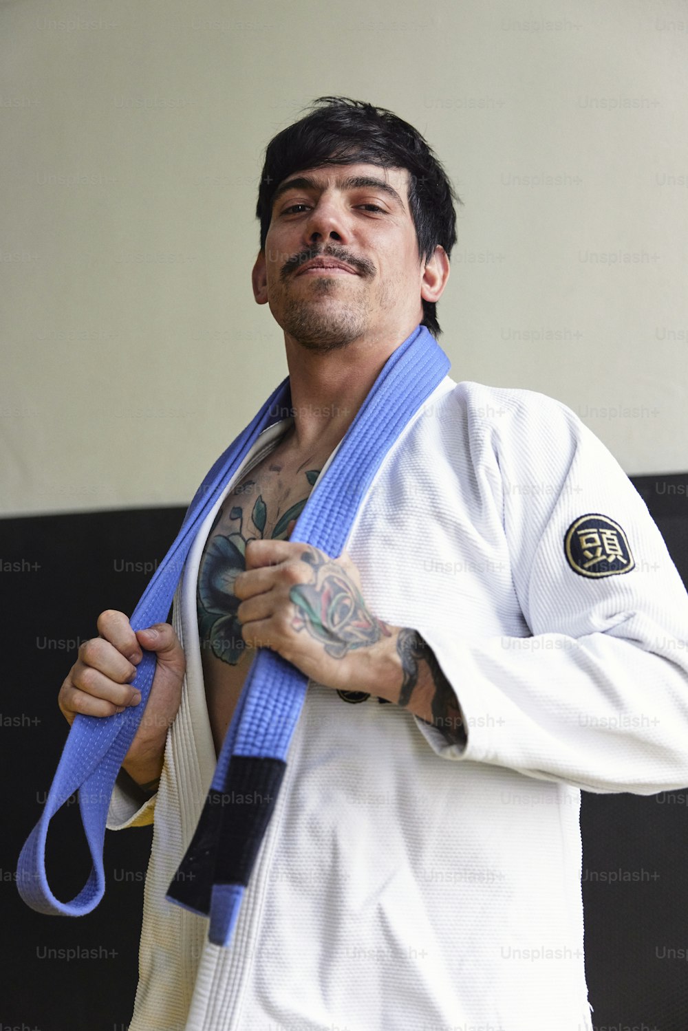 a man with a blue belt around his neck