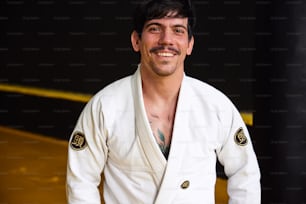 a man in a white kimono posing for a picture