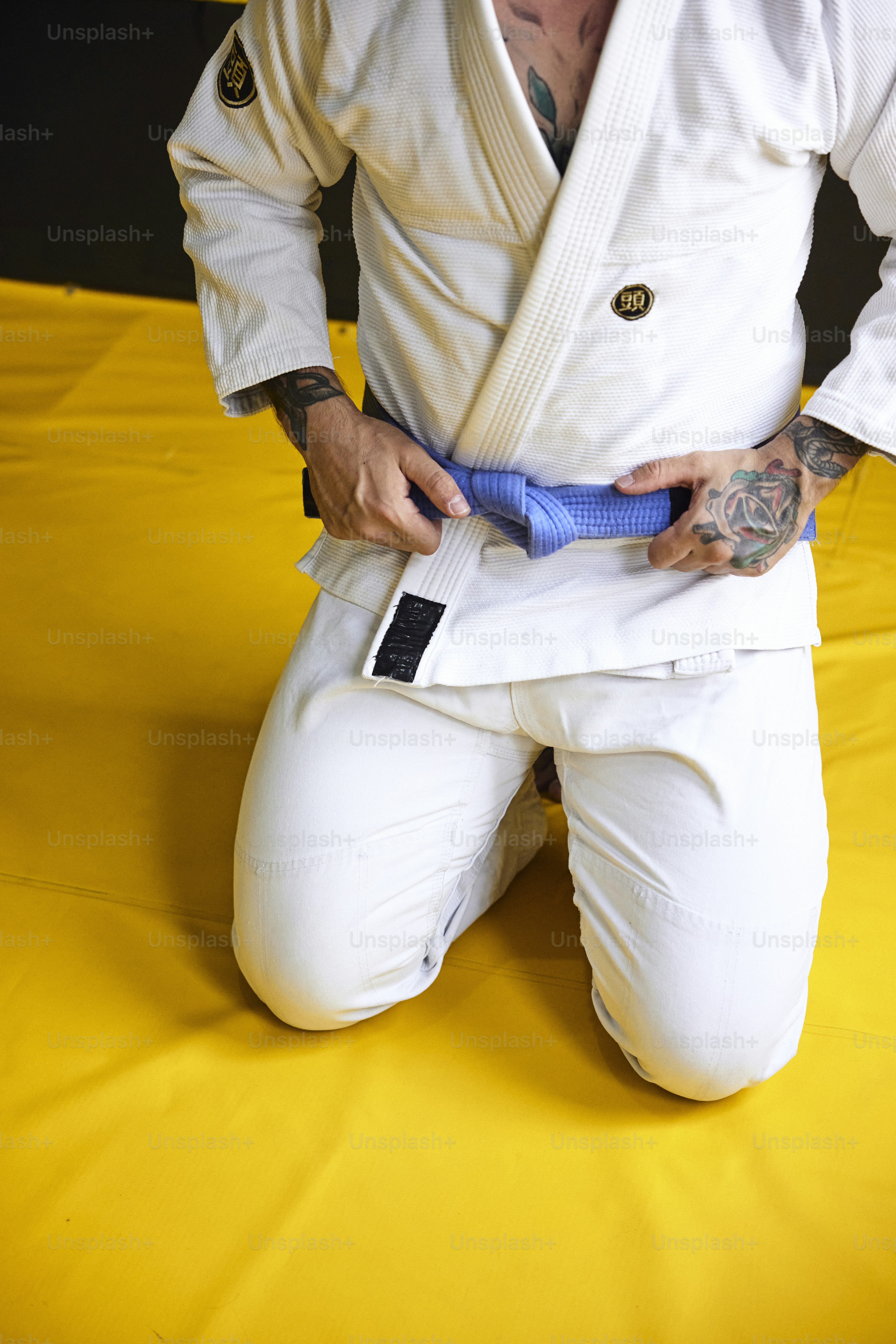 um homem sentado no chão segurando um objeto azul