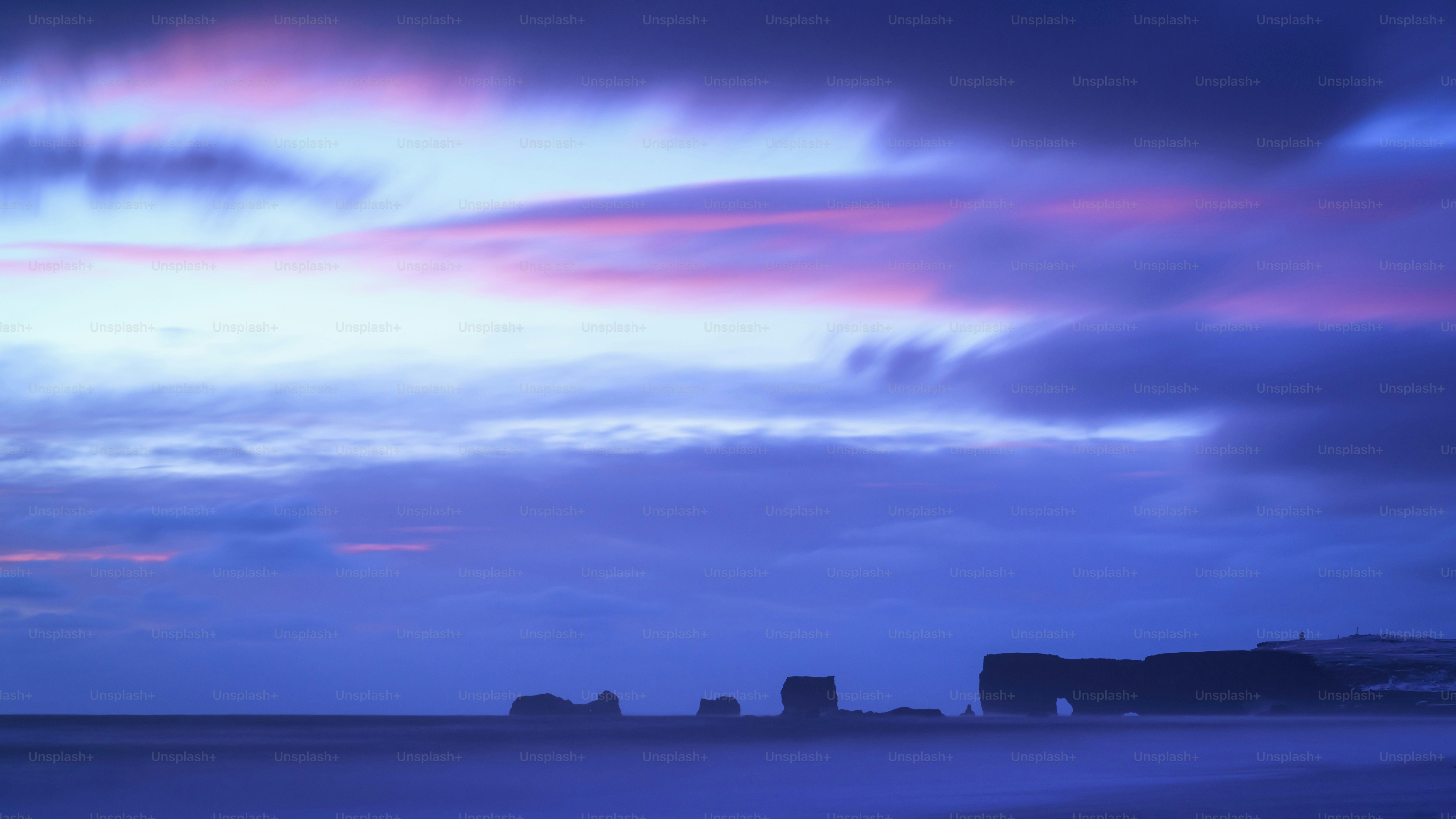 a blue sky with some clouds and some buildings