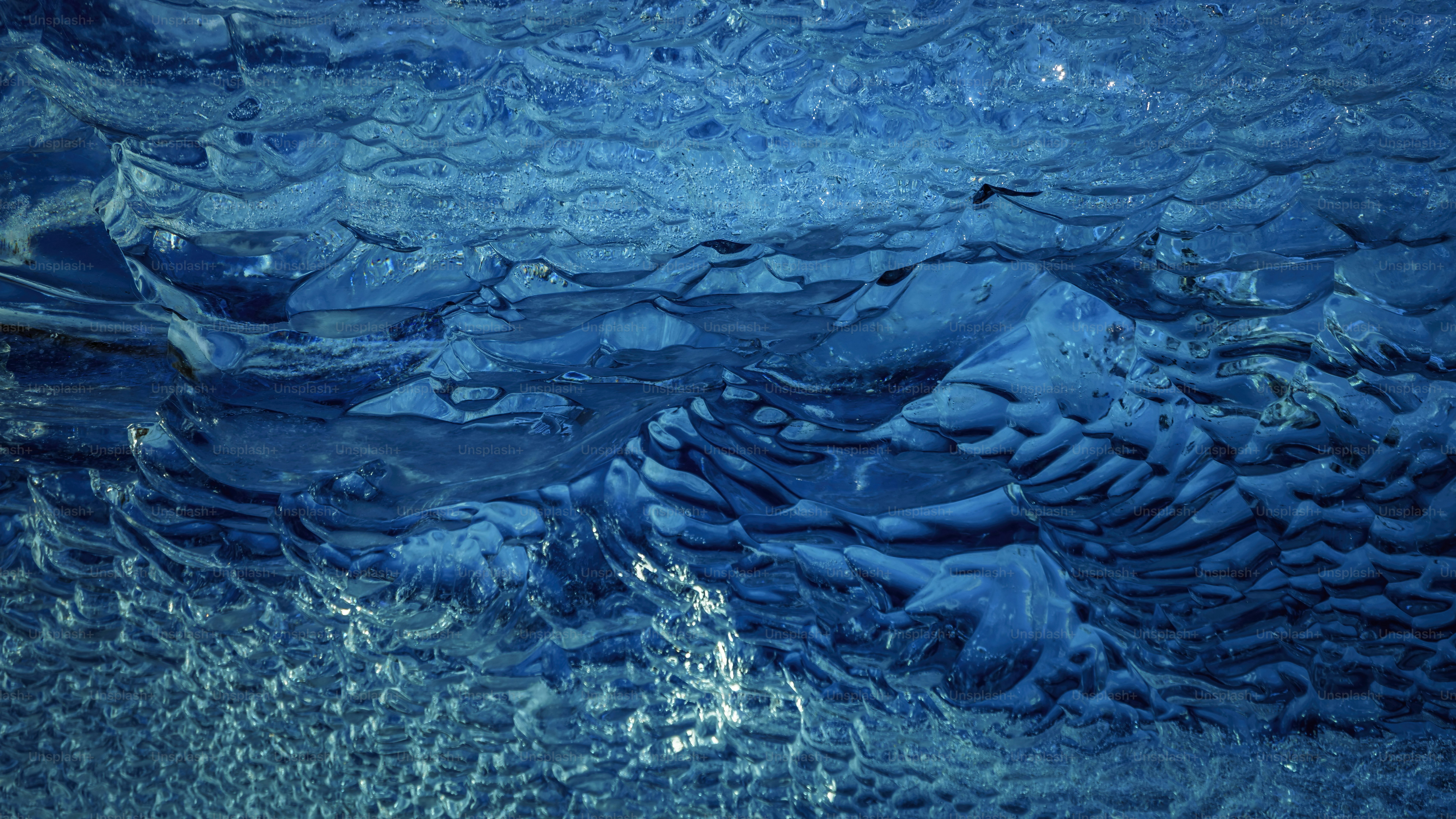 A close up view of a blue water surface photo – Ice Image on Unsplash