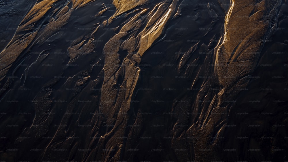 an aerial view of a sandy beach at sunset