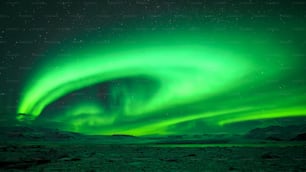 a green aurora bore is seen in the night sky