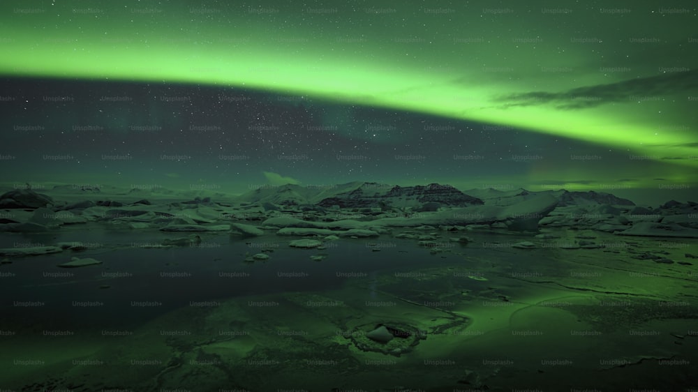 a green and black sky with the aurora in the background