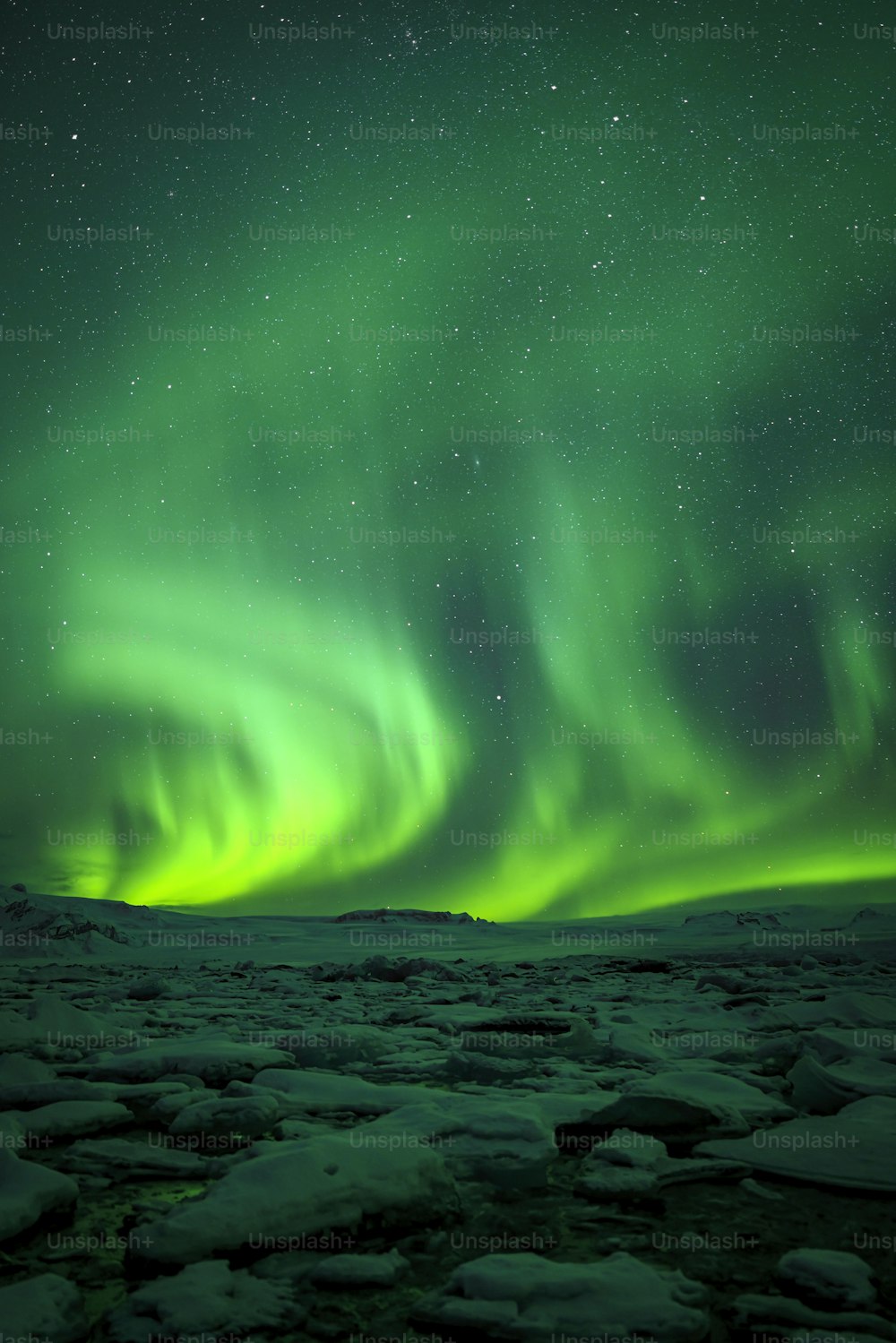 a green and blue sky filled with lots of aurora lights