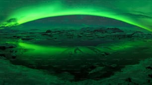a green aurora bore over a frozen lake