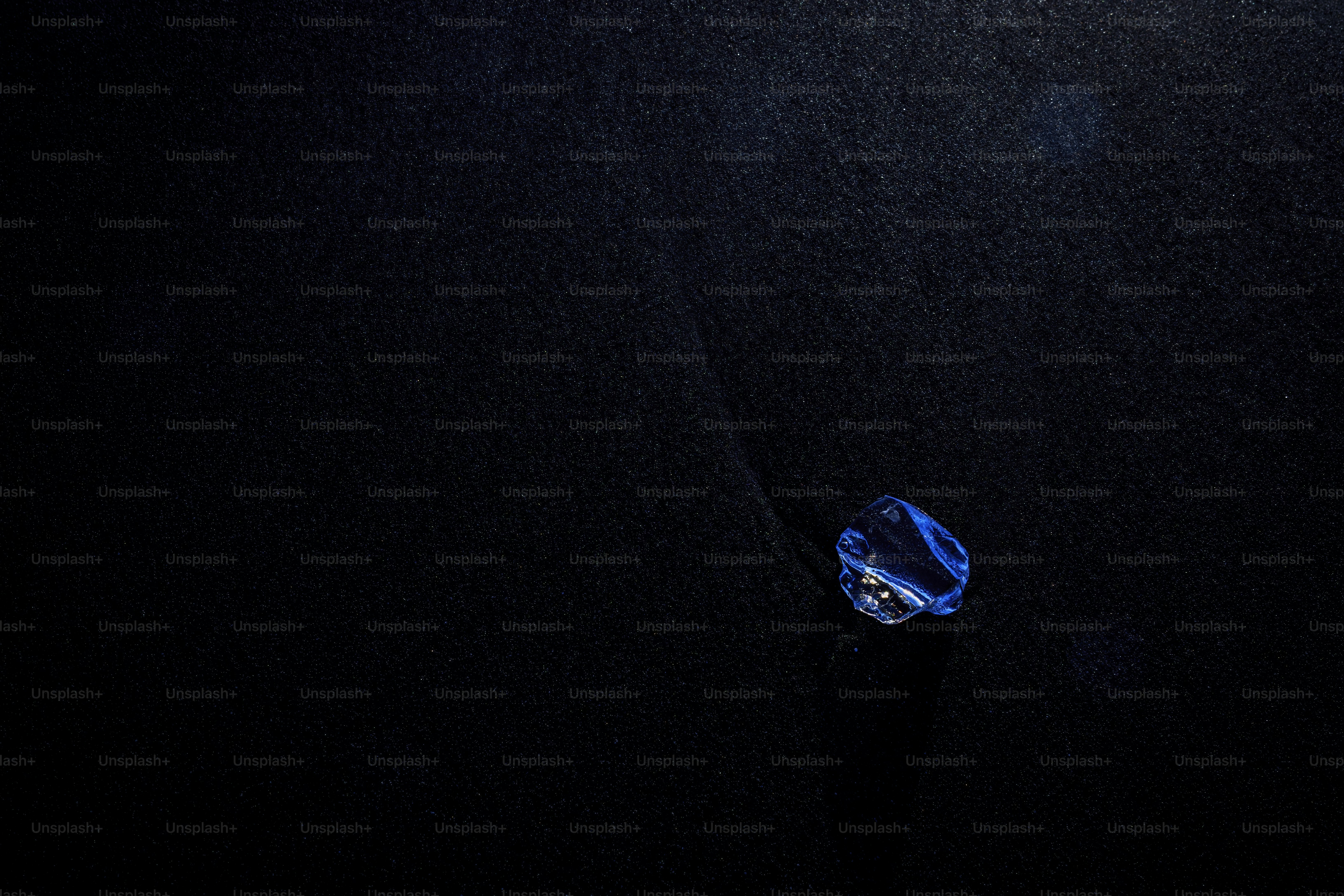 a blue object floating on top of a black surface