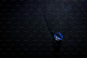 a blue object floating on top of a black surface