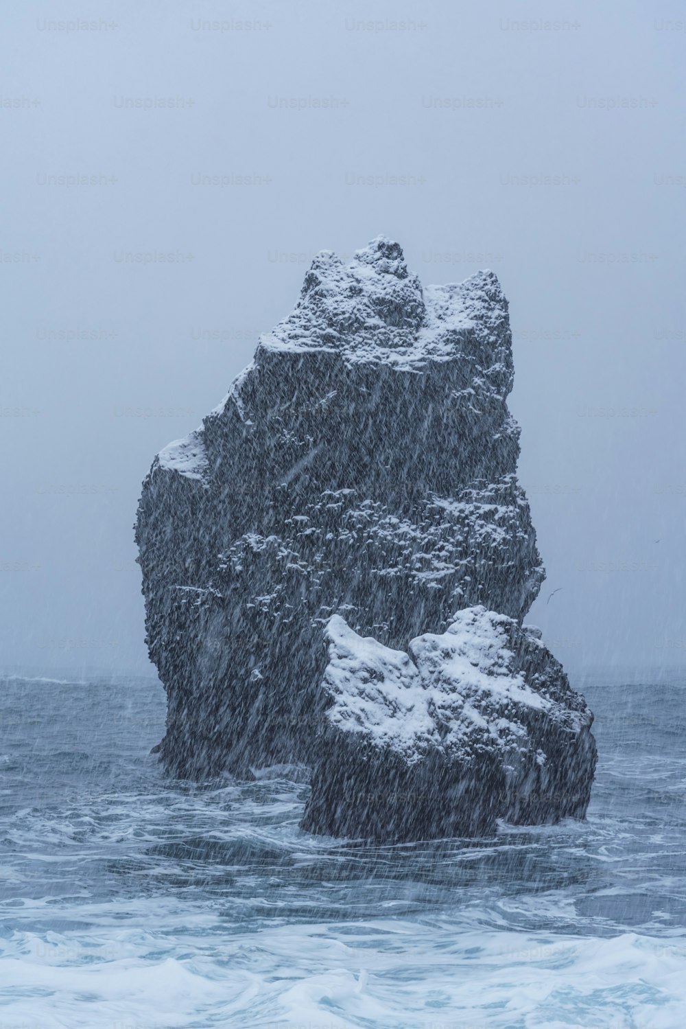 a large rock in the middle of a body of water