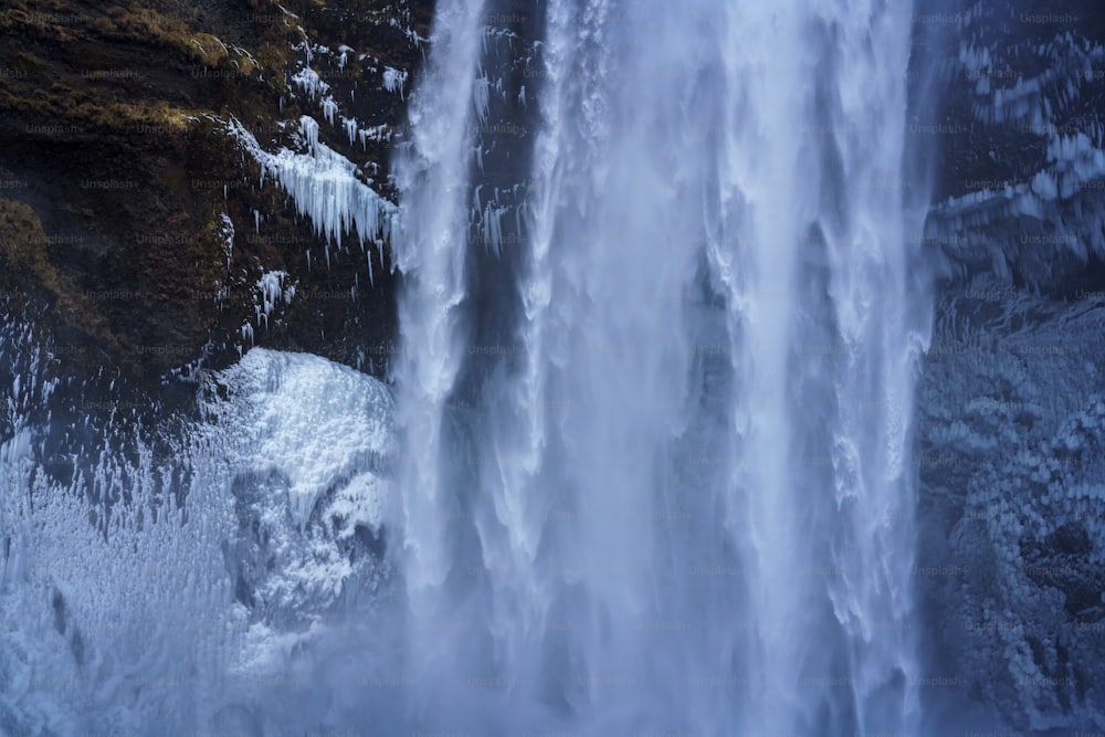 a large waterfall with ice on the side of it