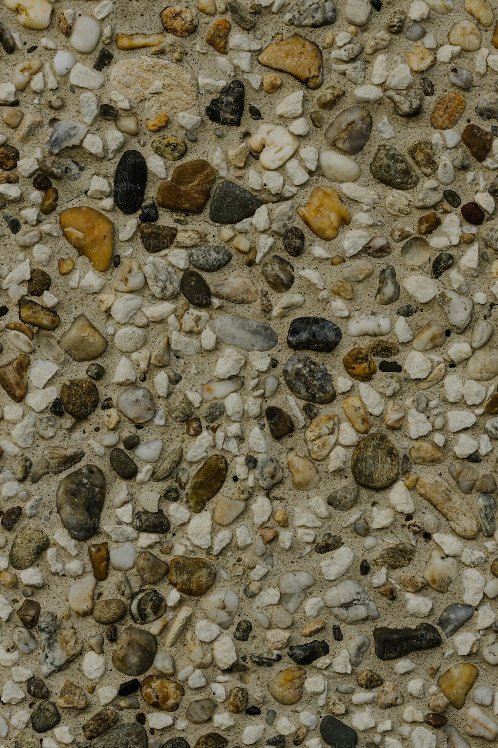 a stone wall covered in rocks and gravel