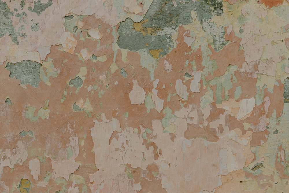 a close up of a wall with peeling paint