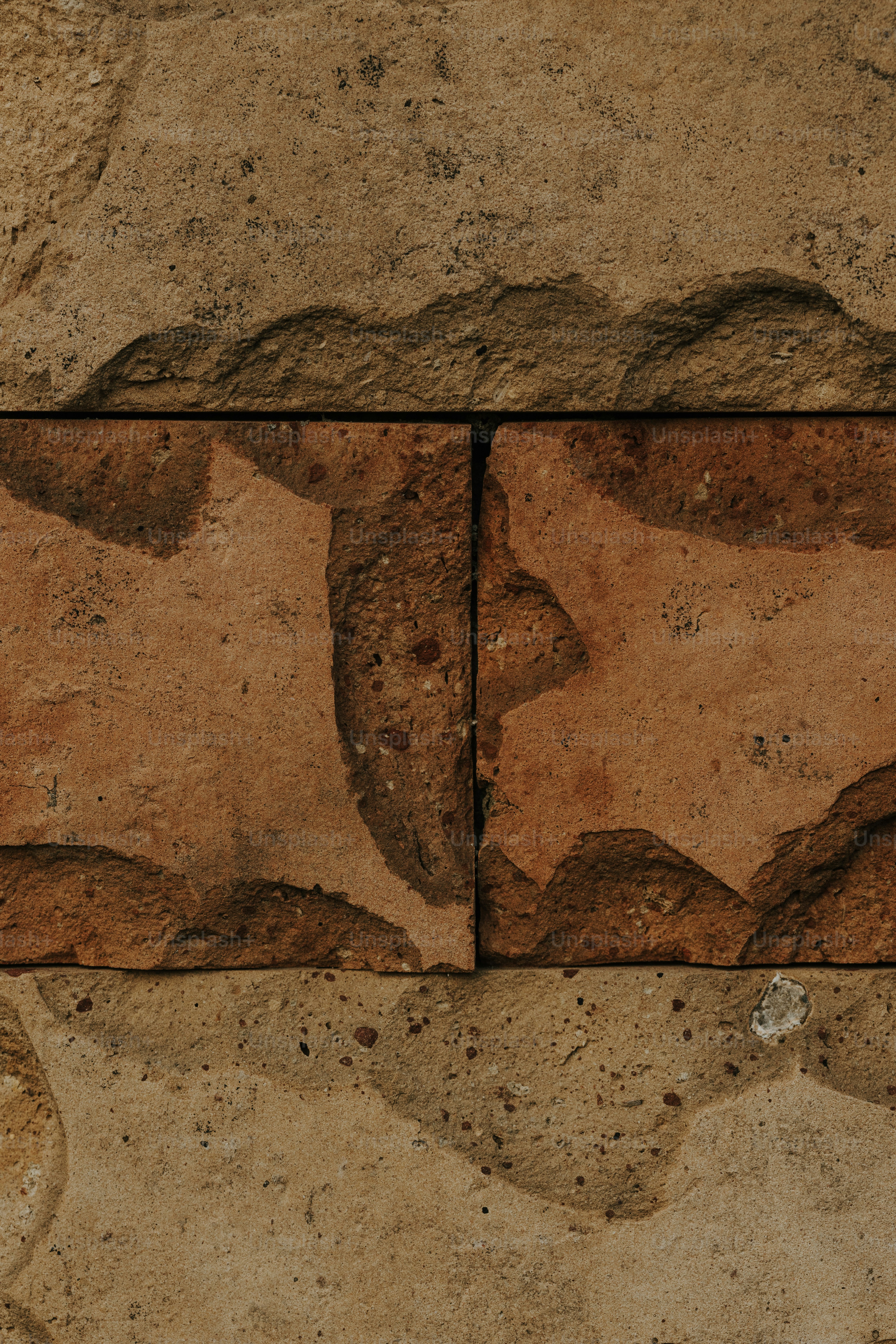 a close up of a stone wall with a clock on it