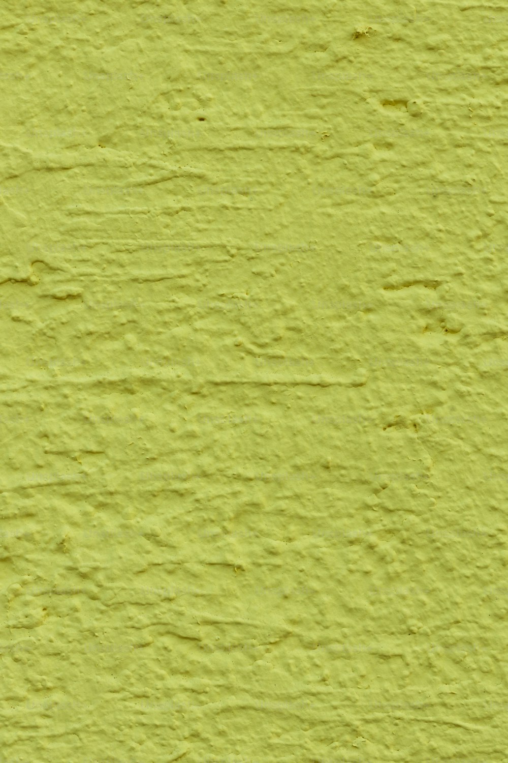 a close up of a yellow painted wall