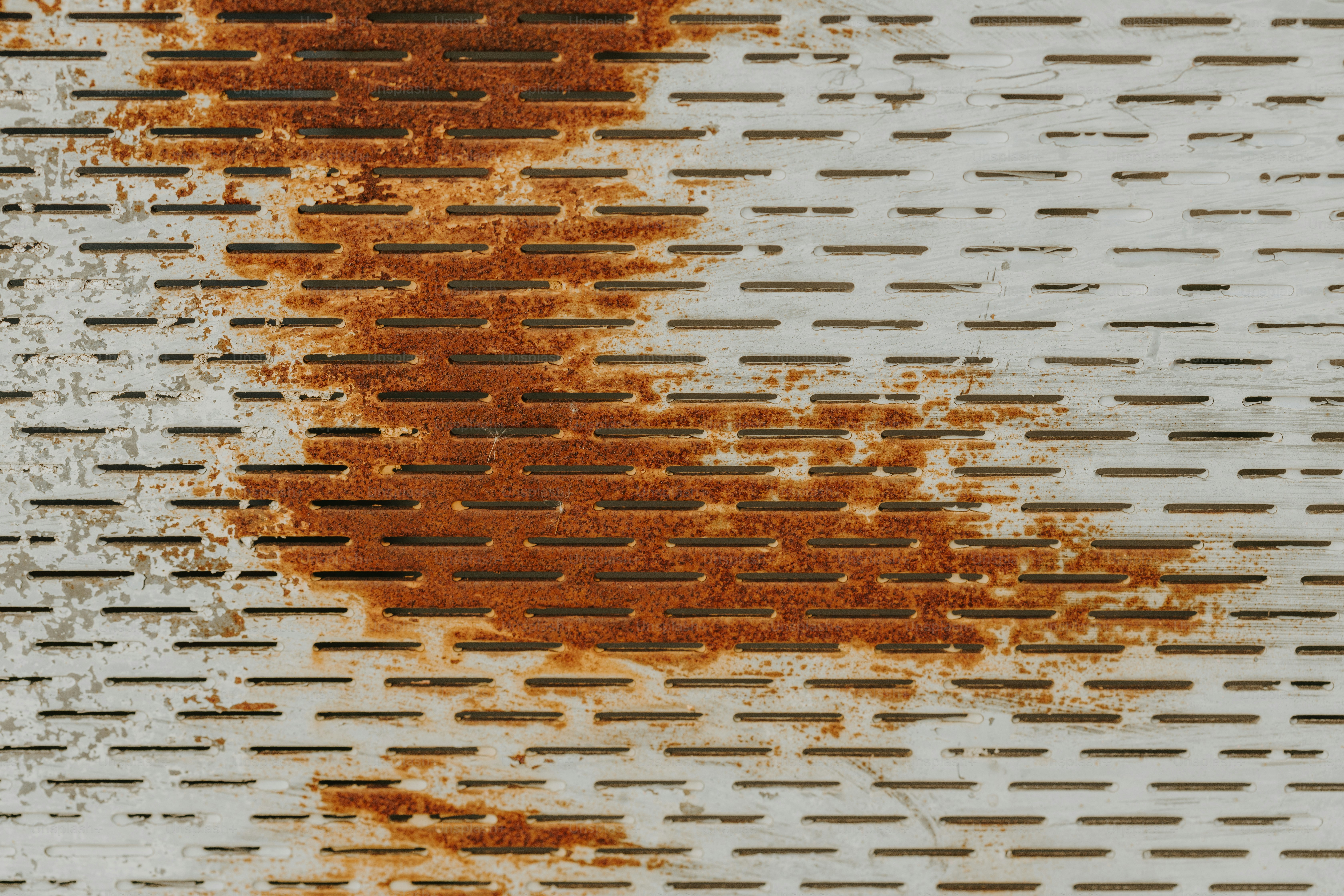 a rusted metal grate with a piece of pizza on top of it