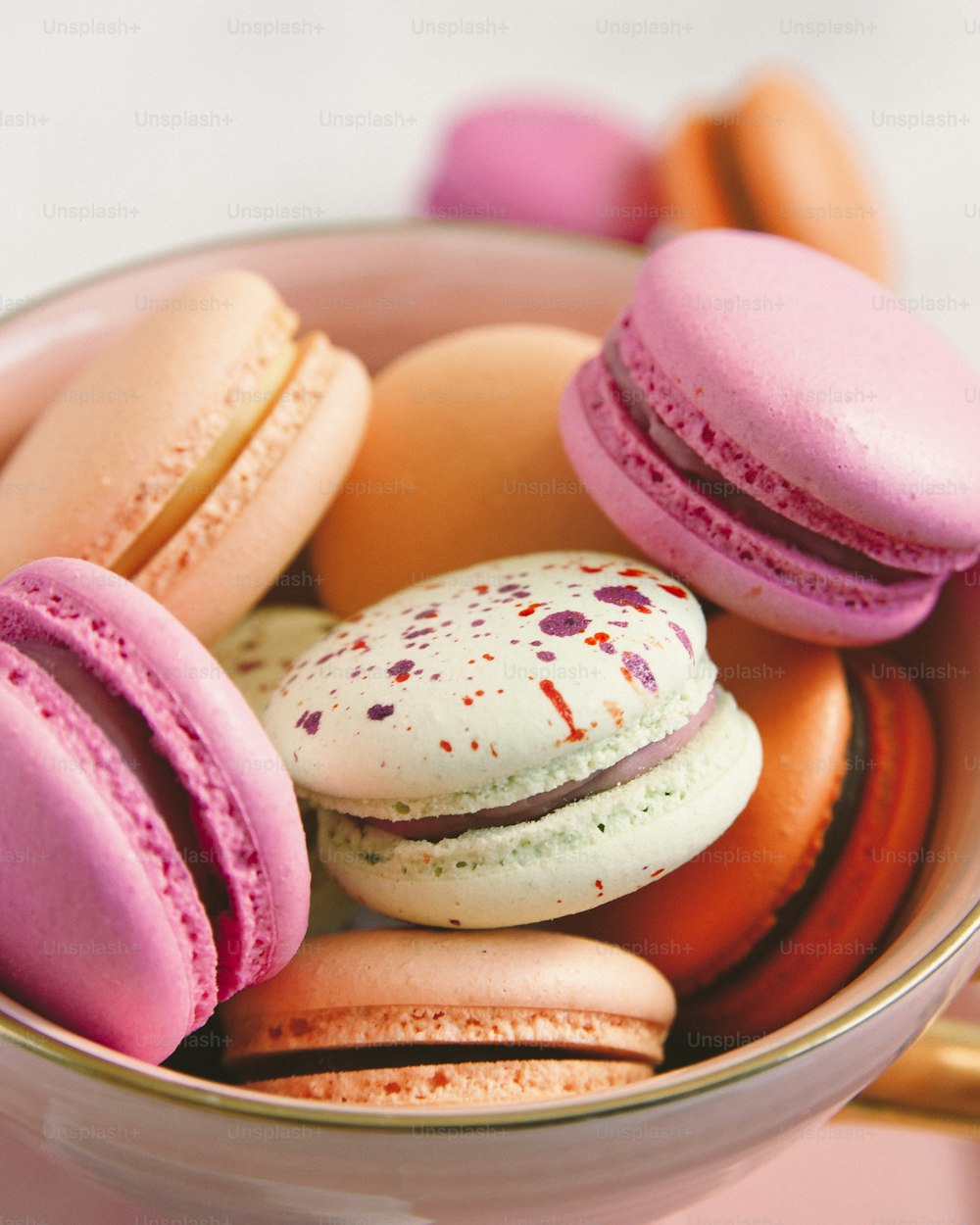 a bowl filled with lots of different colored macaroons