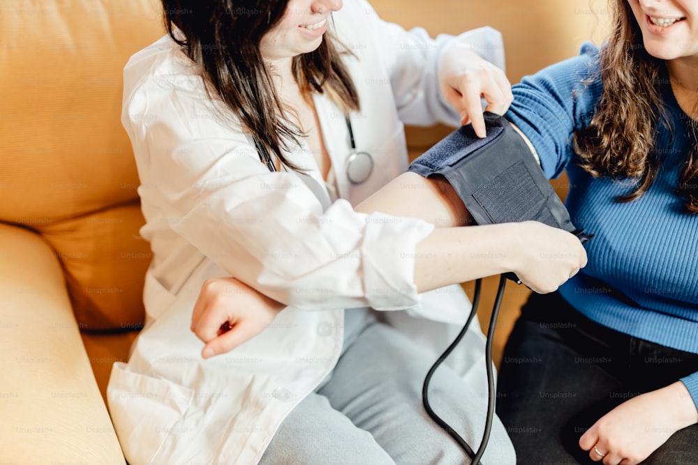 two women sitting on a couch with a stethoscope