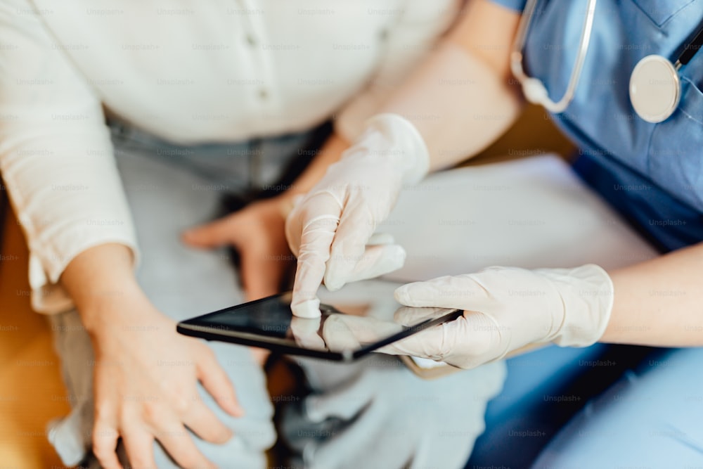 a person in a blue shirt and white gloves holding a cell phone