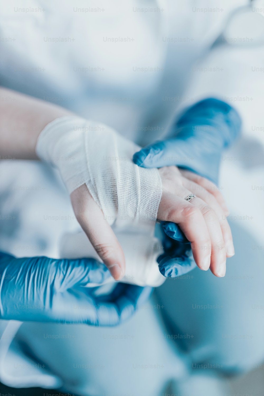 a person in a white shirt and blue gloves
