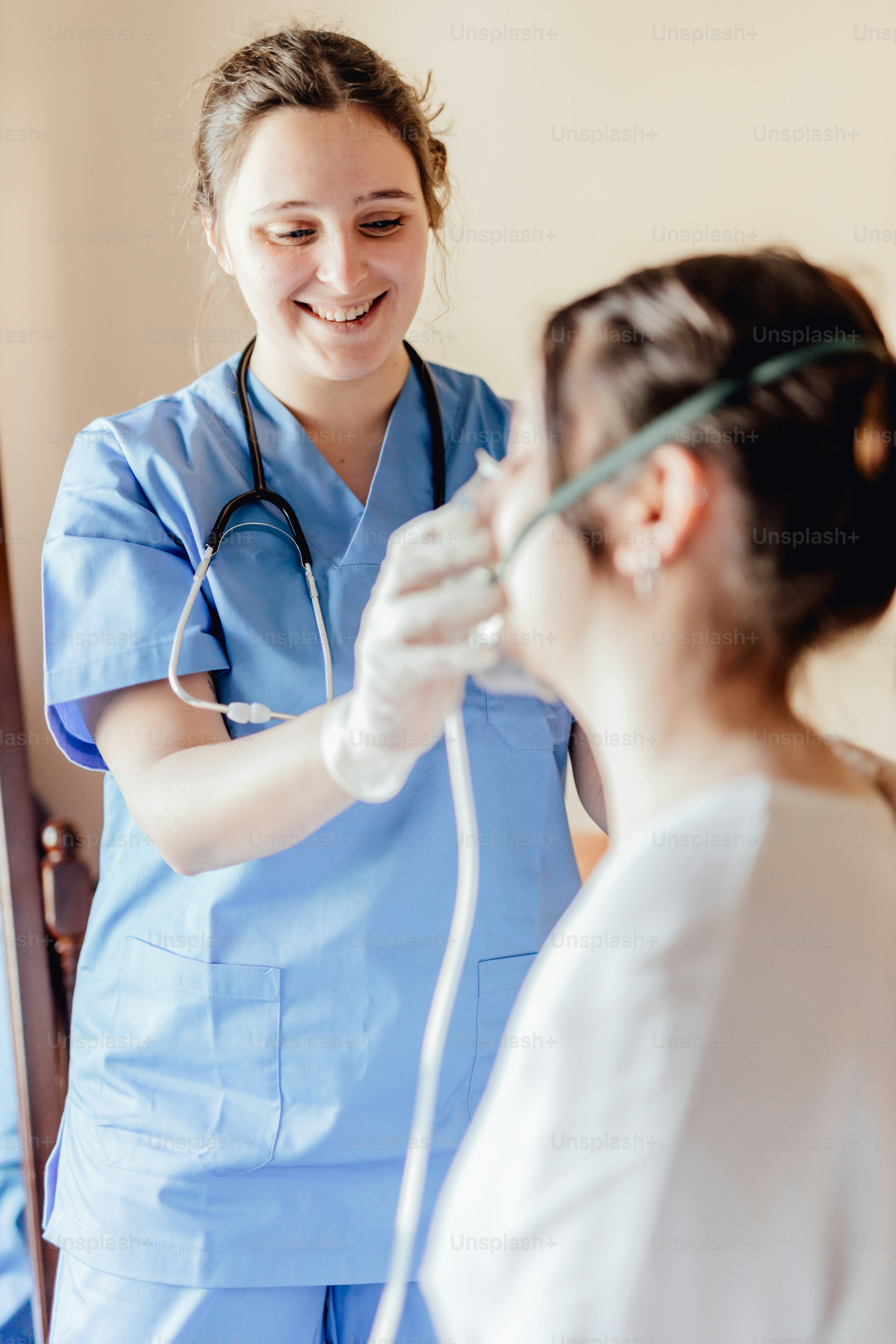 a woman in scrubs and a stethoscope