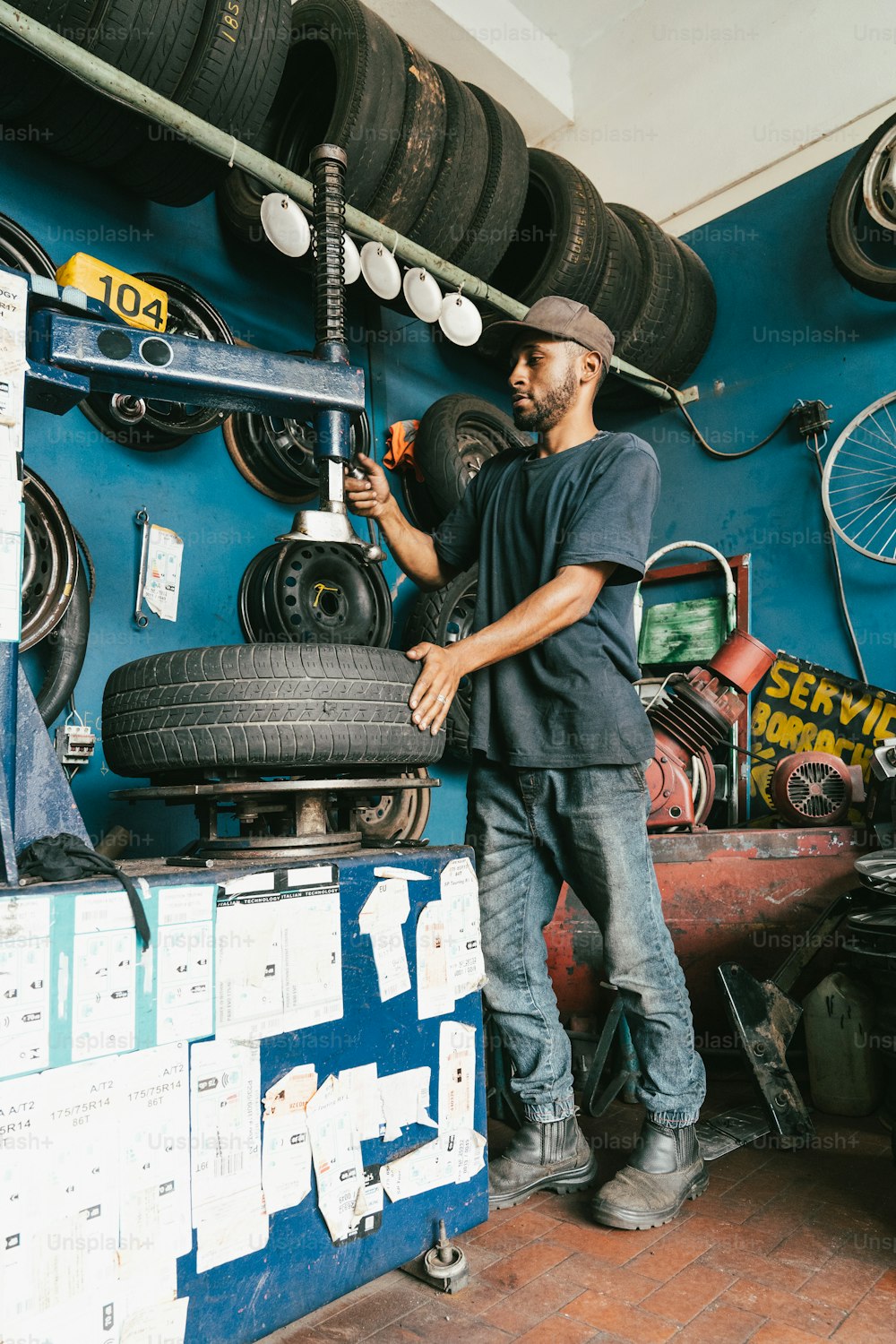 a man working on a tire in a garage