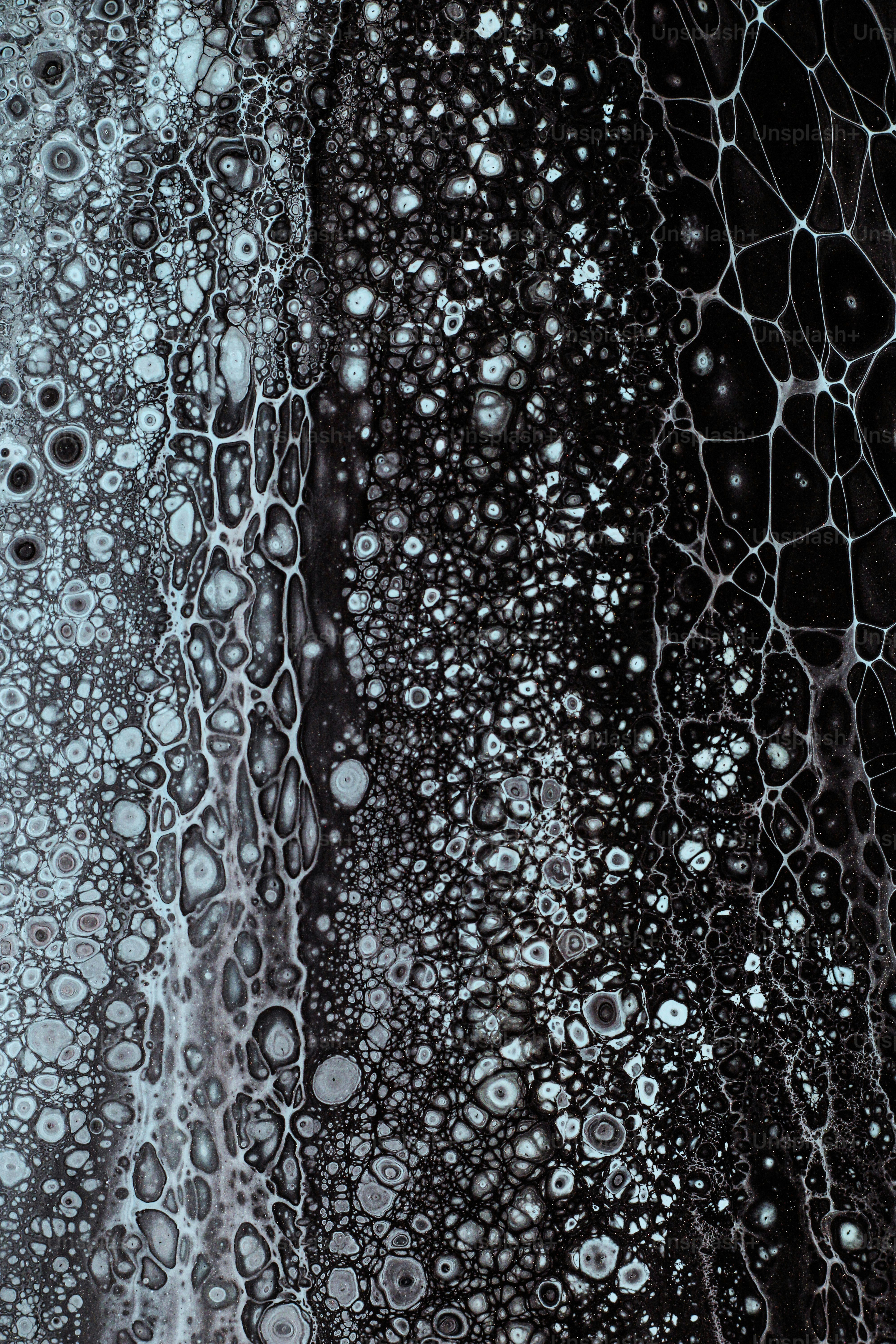 a close up of water droplets on a black surface